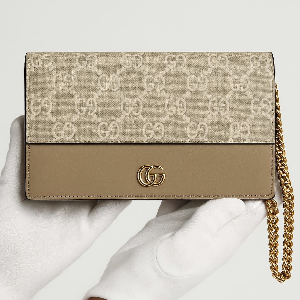 Detail of Gucci GG Supreme Wallet On A Chain gold-tone hardware