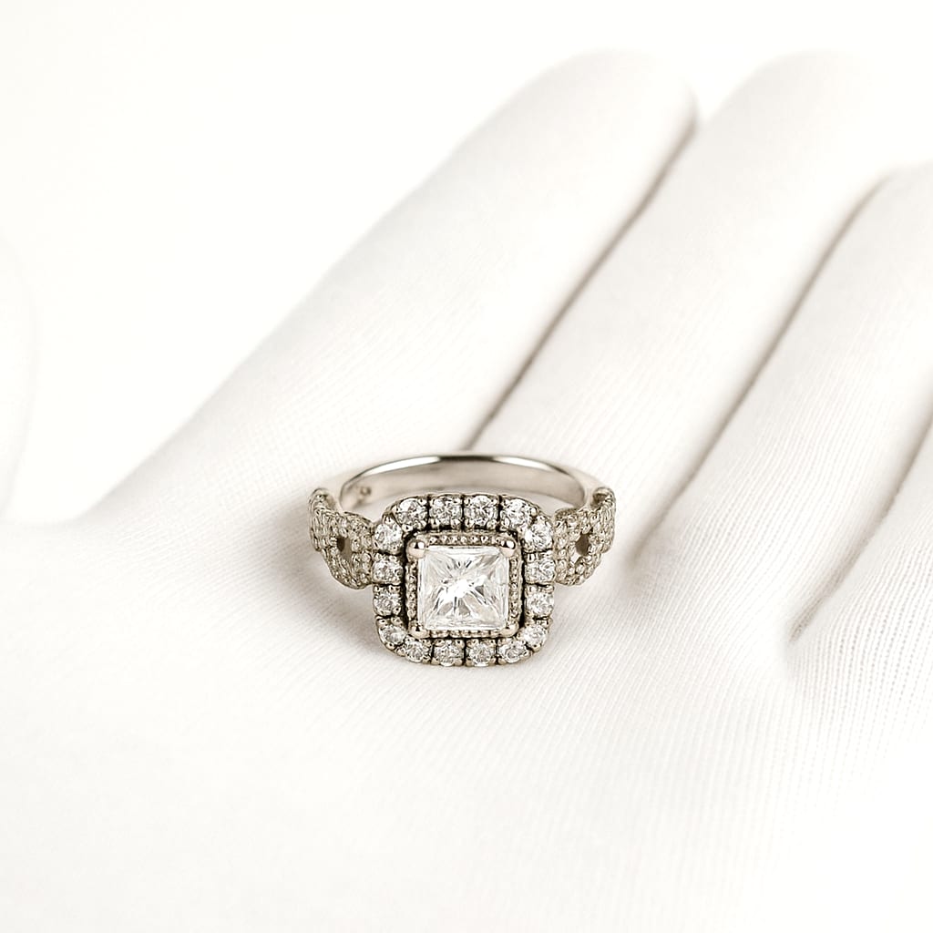 Close-up of Neil Lane ring held by a white-gloved hand.