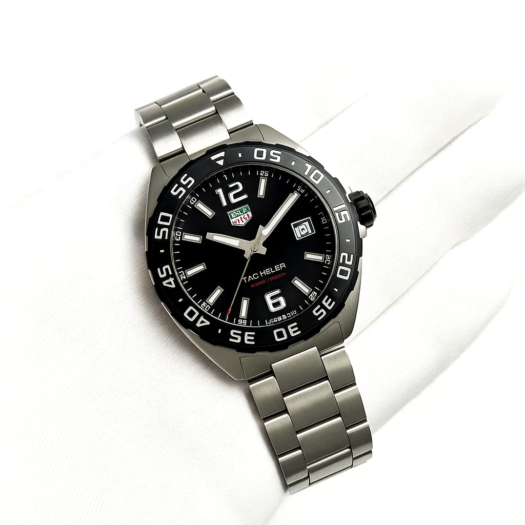 Tag Heuer Formula 1 watch held by a gloved hand