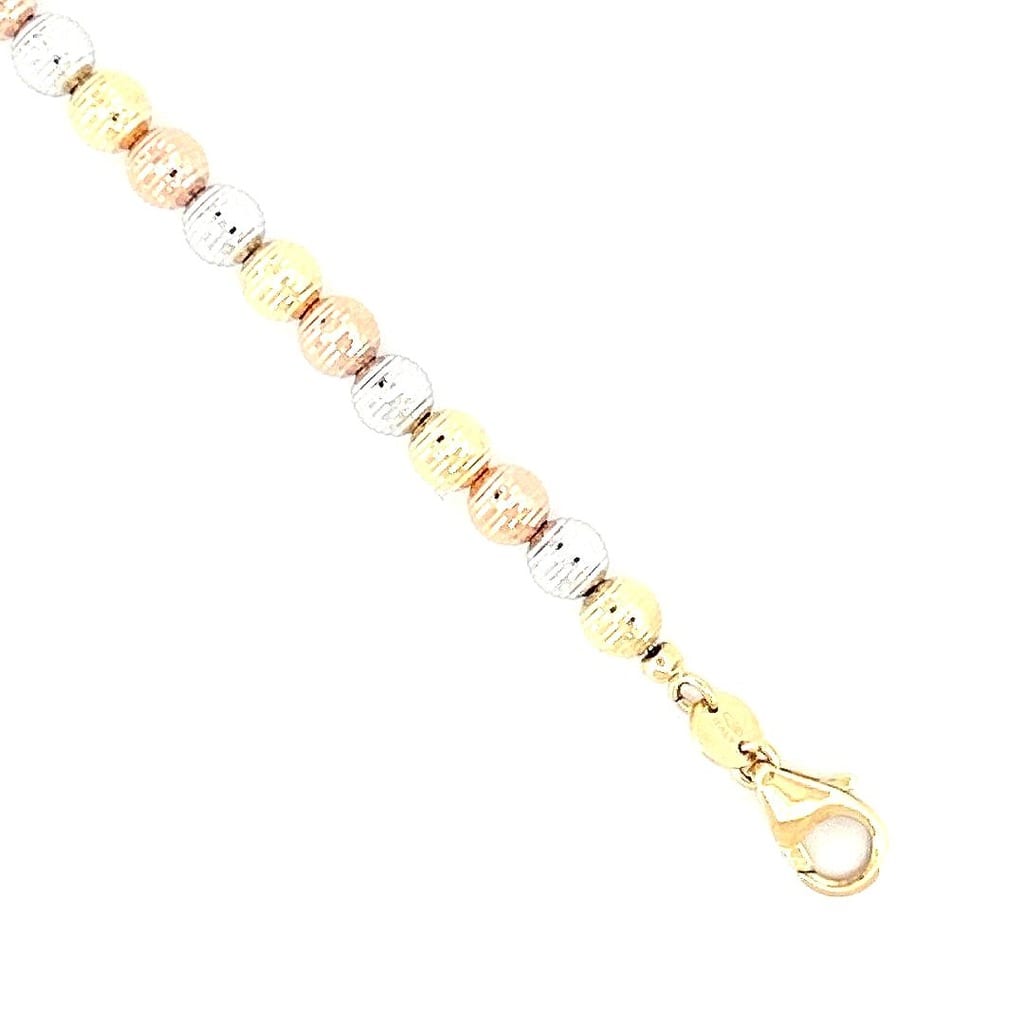 Close-up of the tri-tone gold beads on the bracelet