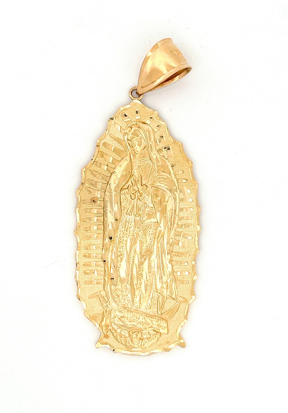 Close-up of Our Lady of Guadalupe engraving on pendant